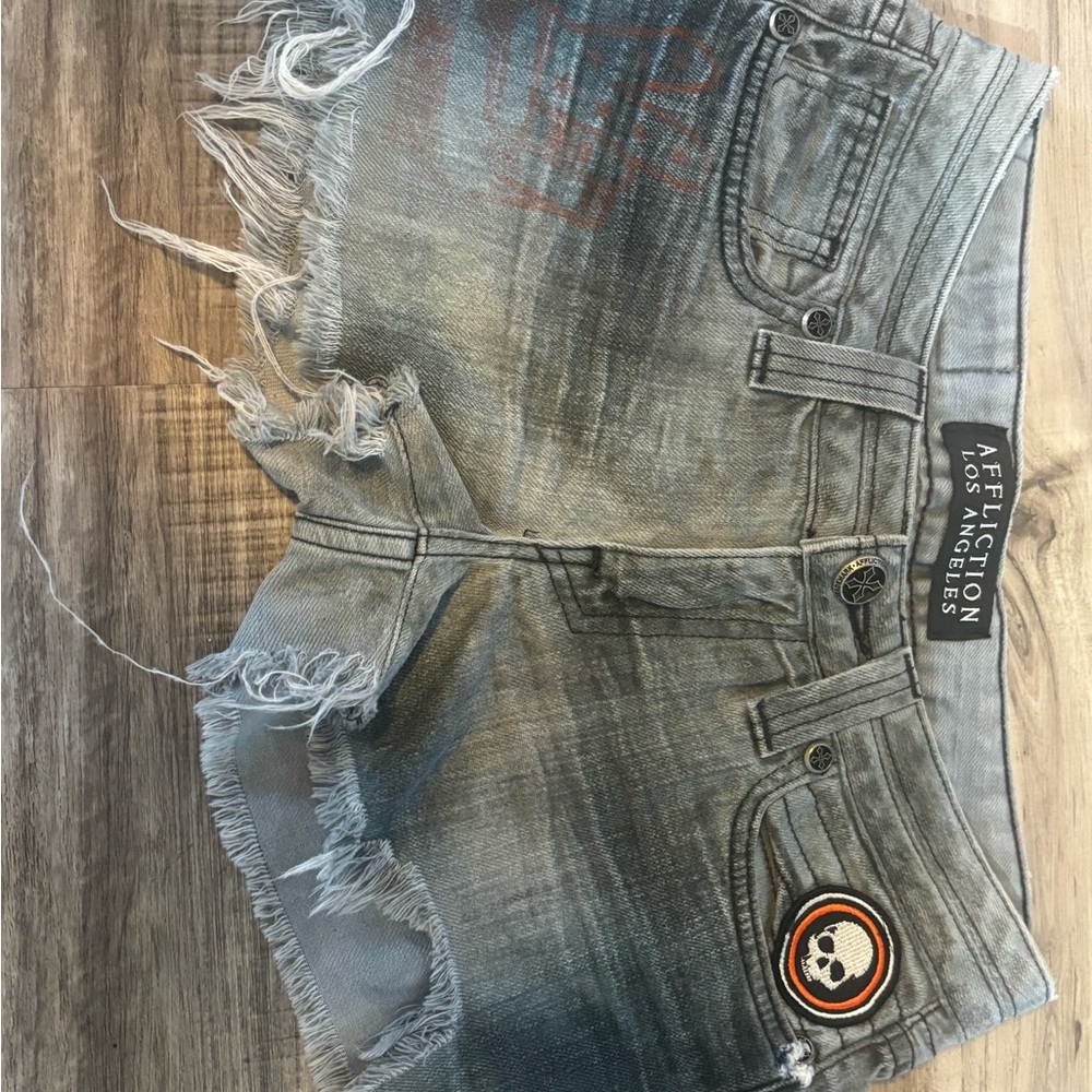 Affliction Jean shorts. Lots of patches. Sz. 26. Worn only a couple times.